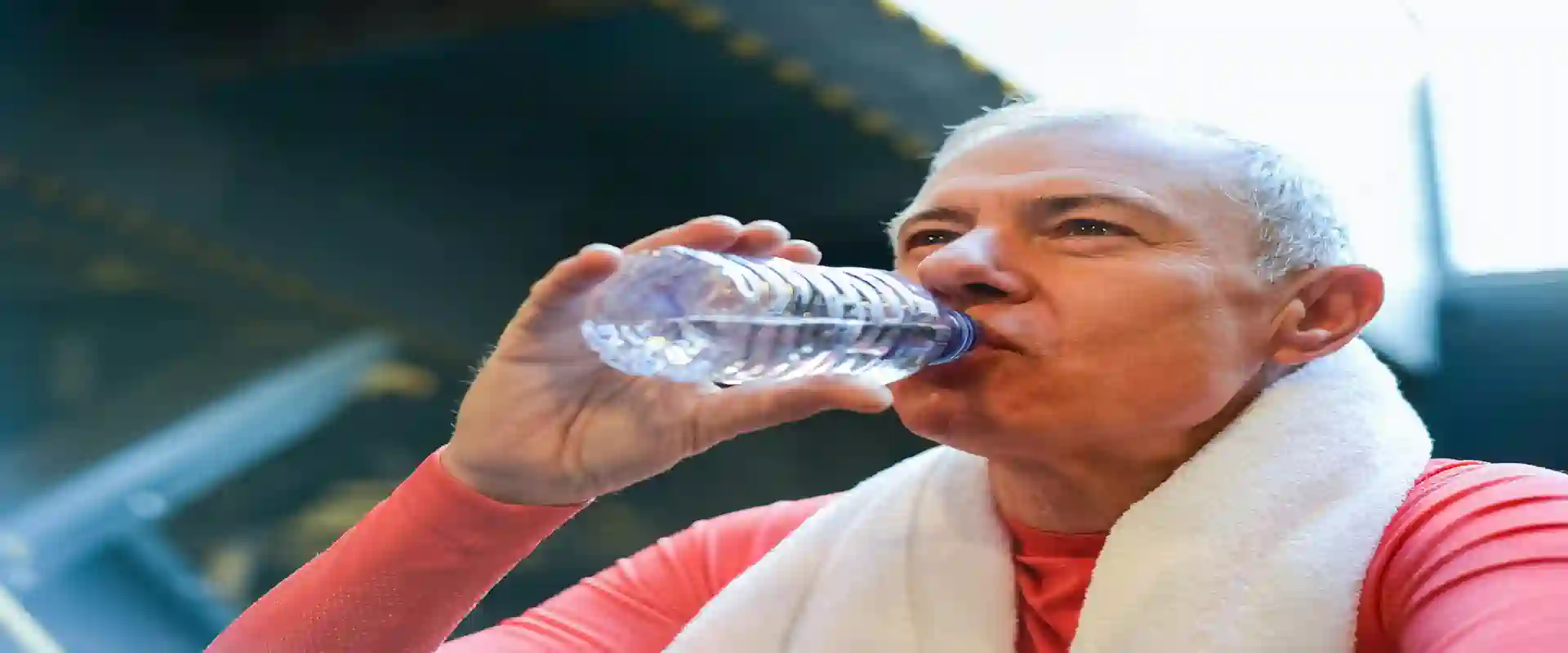 Older adult drinking water after a workout, illustrating exercise during and after chemotherapy